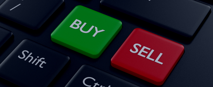 Image of a computer keyboard featuring distinct buy and sell buttons for trading activities.