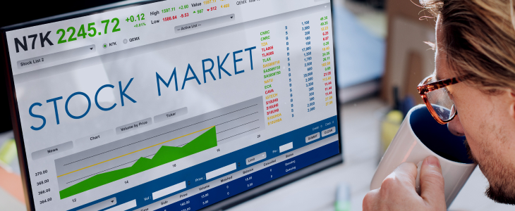 A stock market display showing fluctuating graphs and numbers in the background, indicating market activity.
