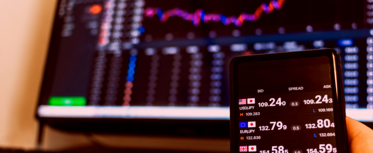 A smartphone displaying a forex trading app interface with charts and currency pairs for mobile trading.