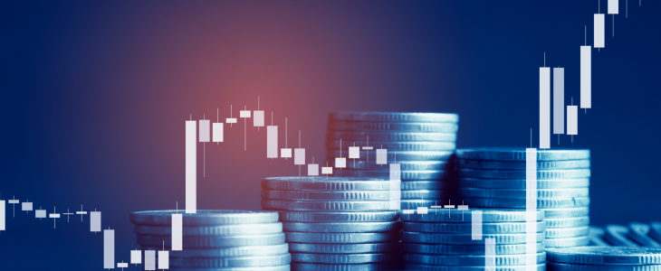 Stacked coins on a table with a rising trend line, symbolizing financial growth and investment success.