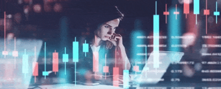 A woman focused on her laptop, analyzing a stock chart displayed on the screen.