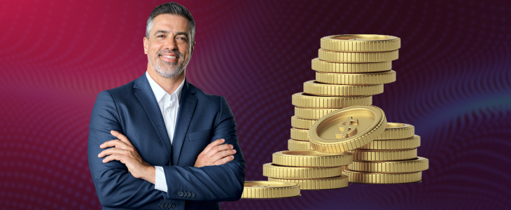 Smiling businessman in a suit standing with folded arms next to stacks of gold coins on a purple gradient background